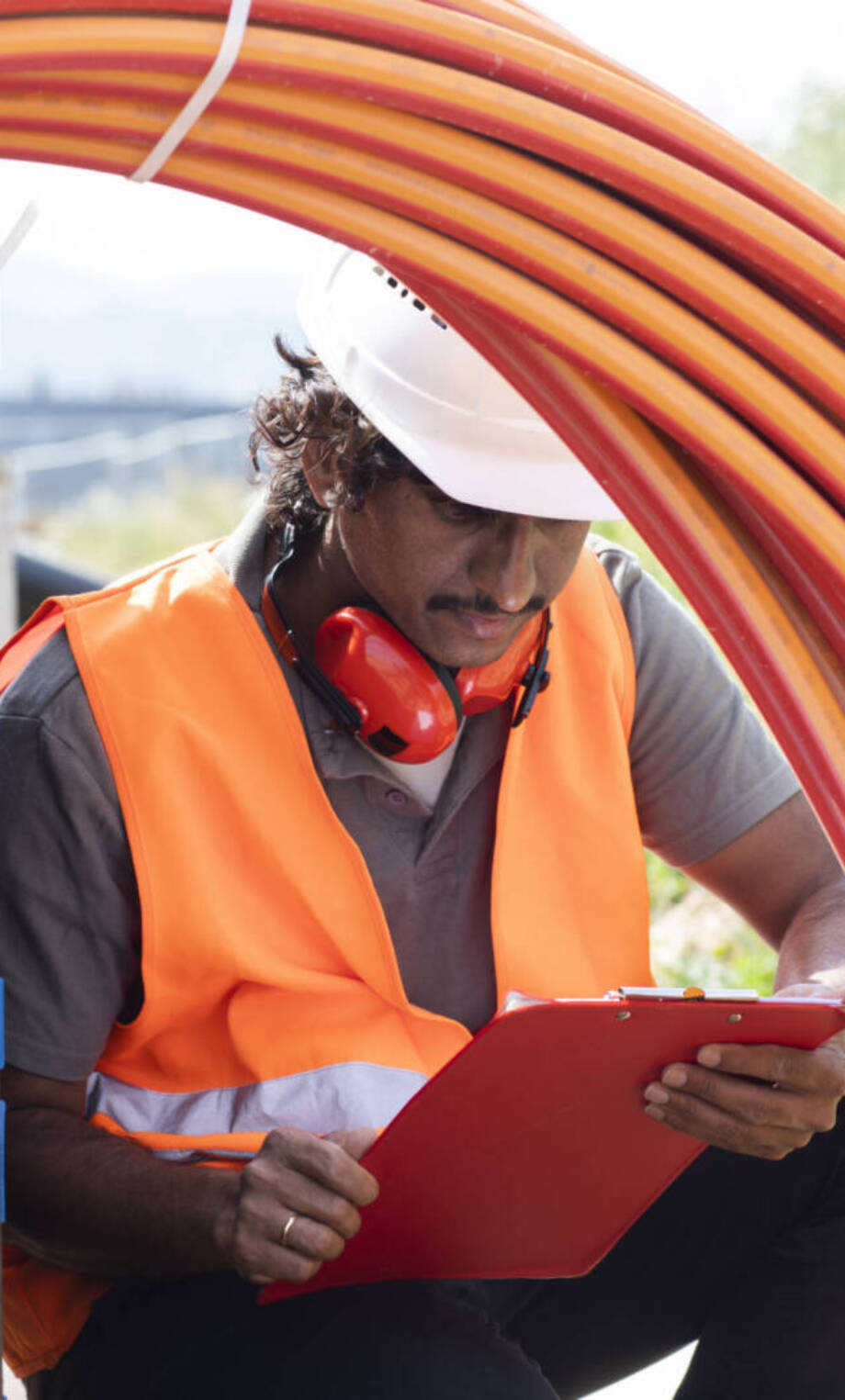 Construction engineer with helmet and clipboard